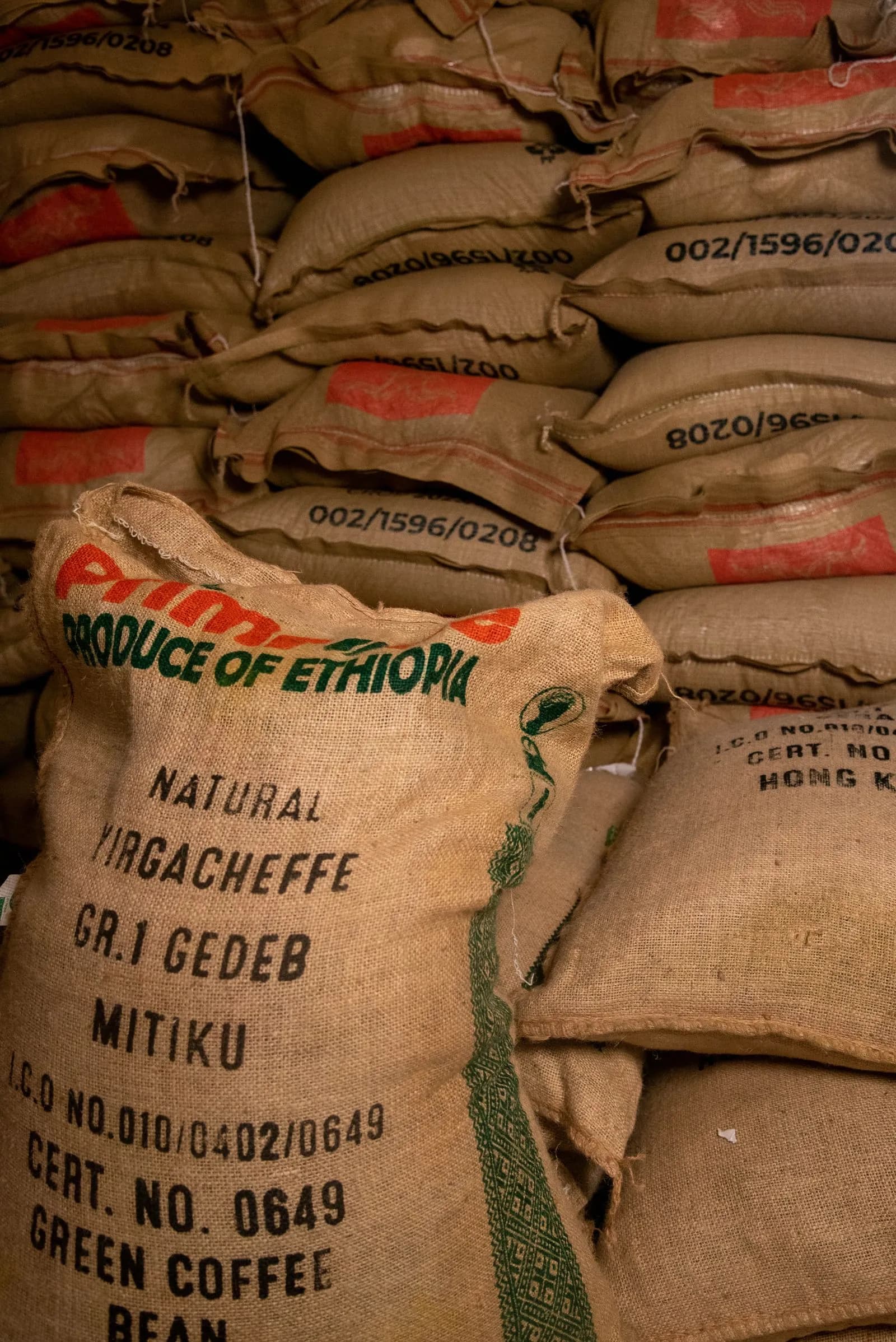 Marked green coffee sacks, including Yirgacheffe, illustrating supplier lot inputs for coffee roastery traceability